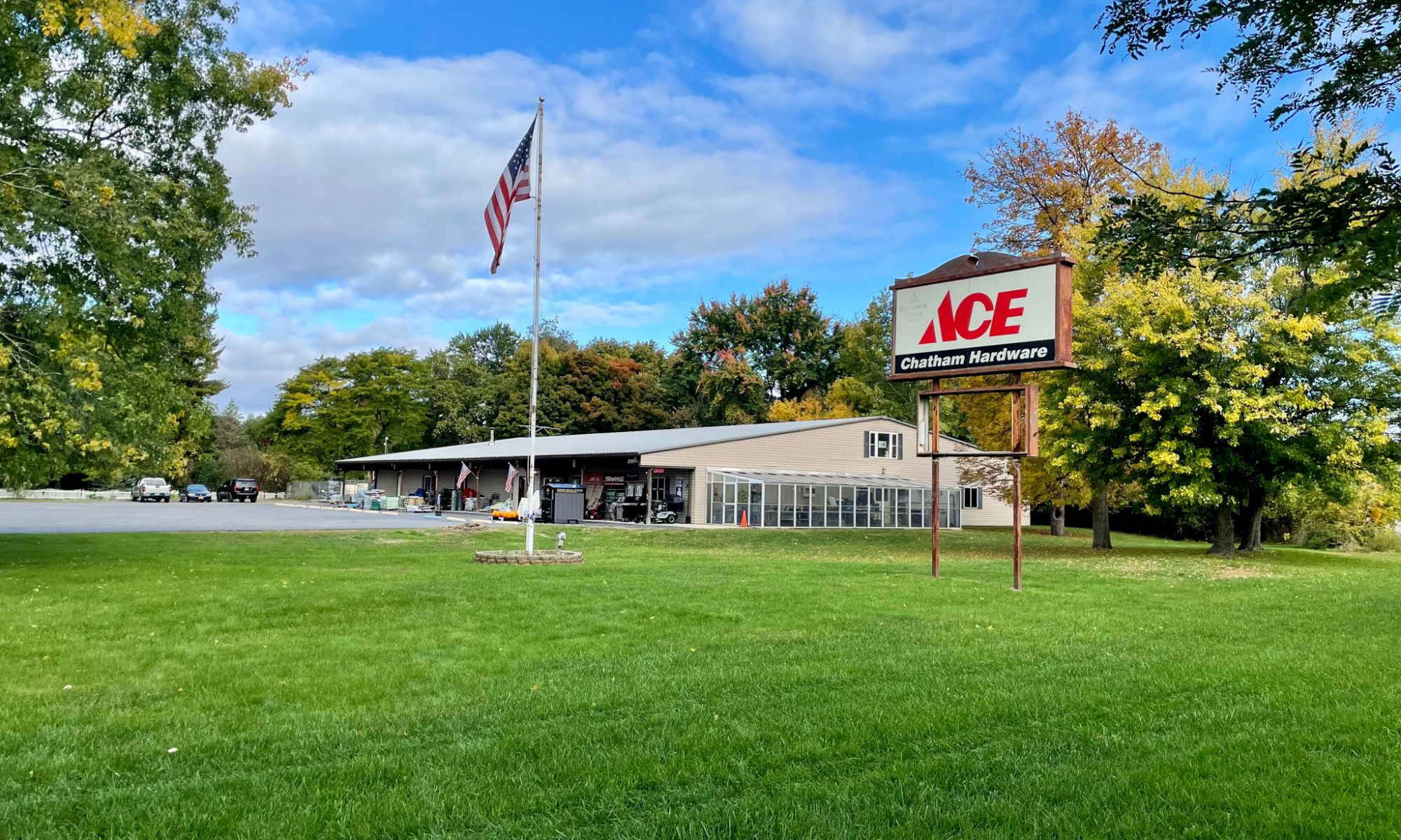 Exterior view of Chatham Hardware with a sign and an American Flag